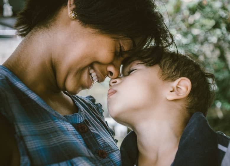 young boy’s nose touching his mother’s nose