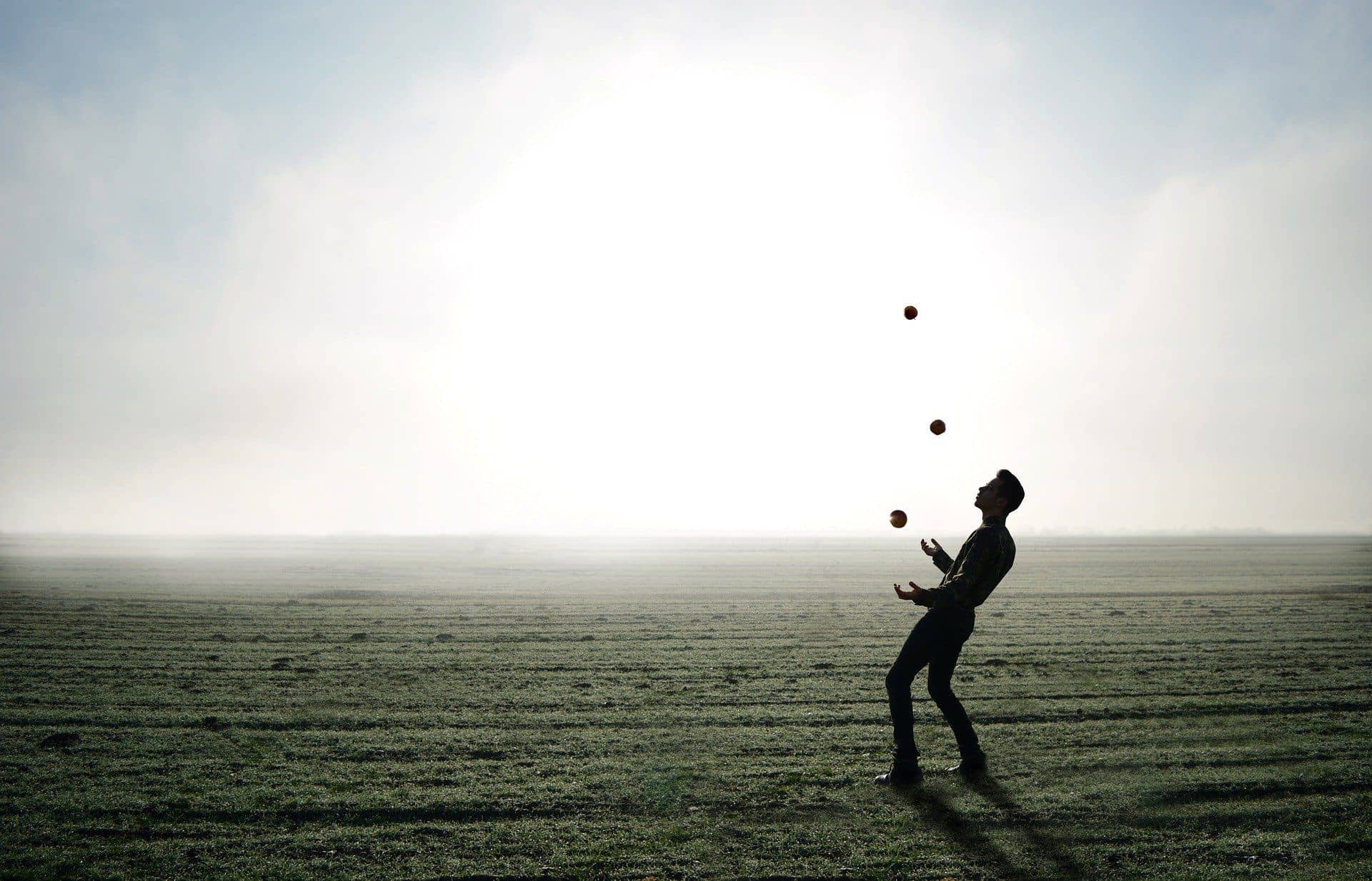 man juggling in the field