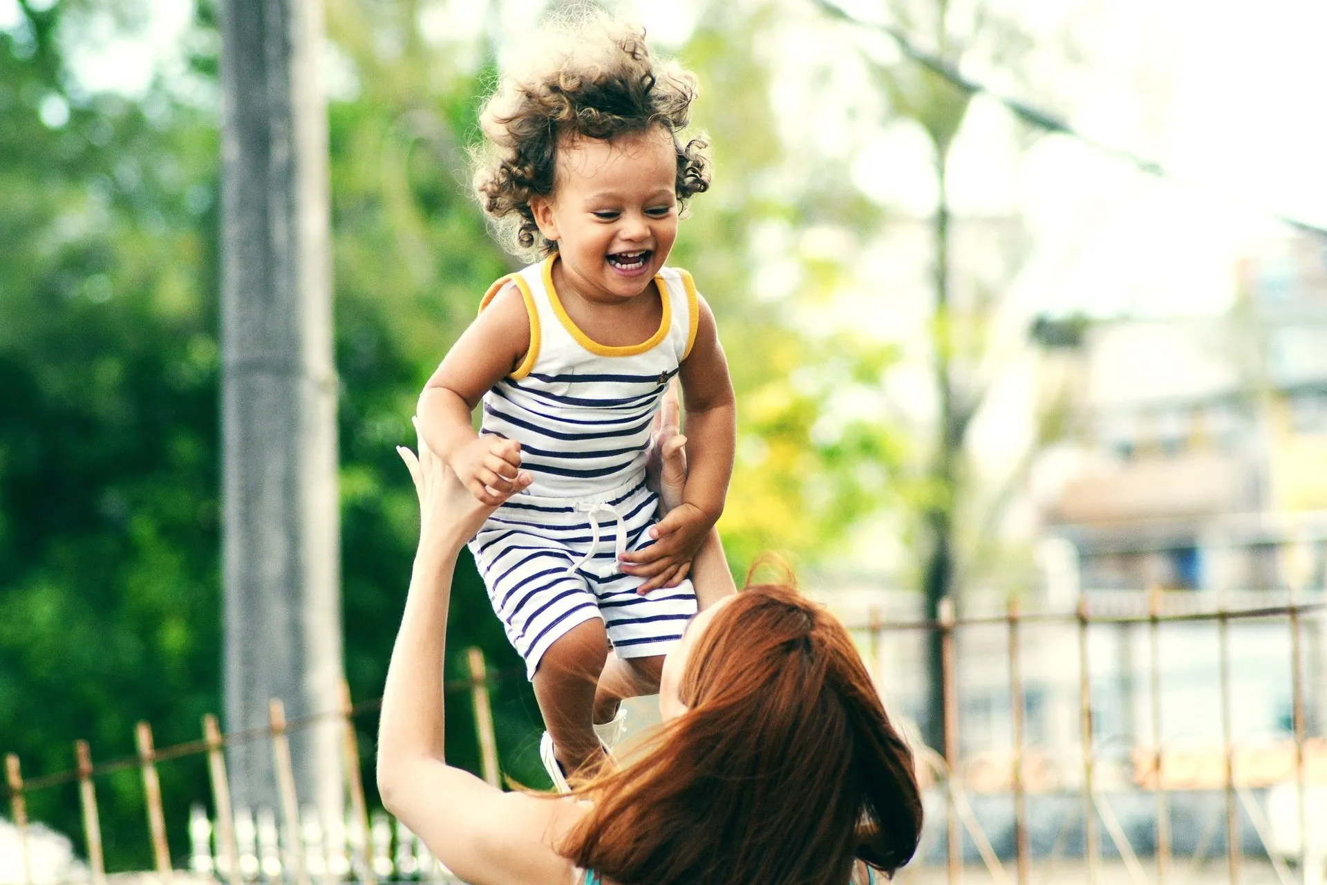 woman lifting a young boy up