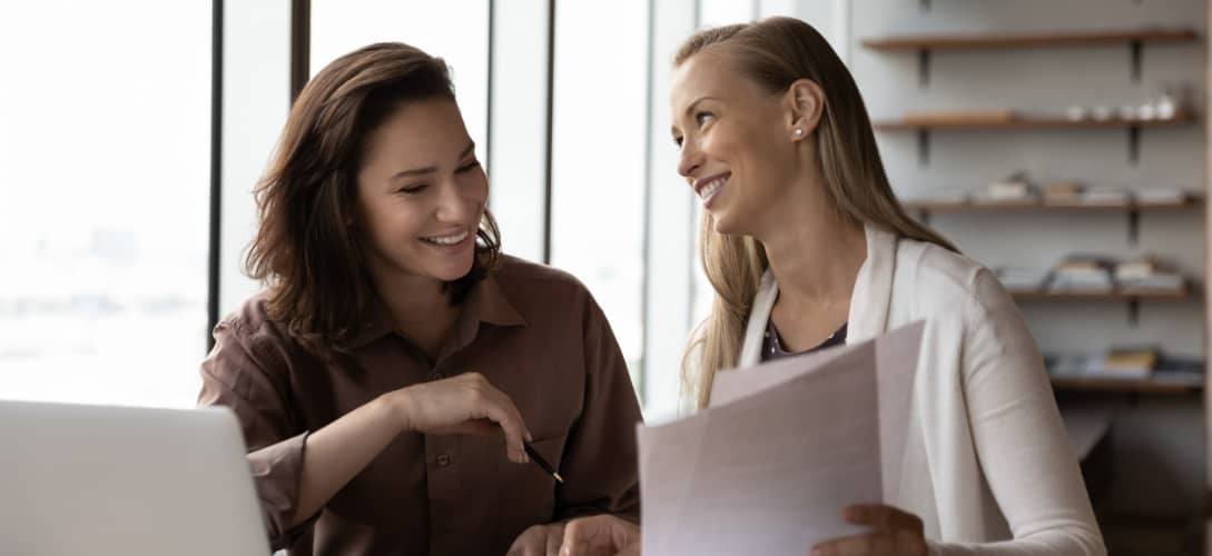 Happy business colleagues analyzing, reviewing divorce tips for women papers, legal documents together